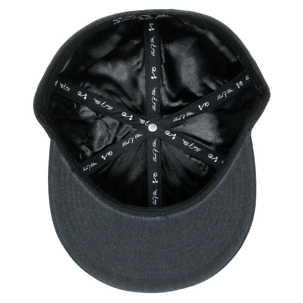 Black fitted hat with printed fabric lining and central crown button