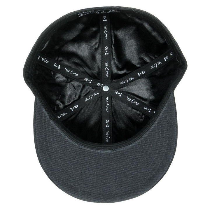 Black fitted hat with printed fabric lining and central crown button