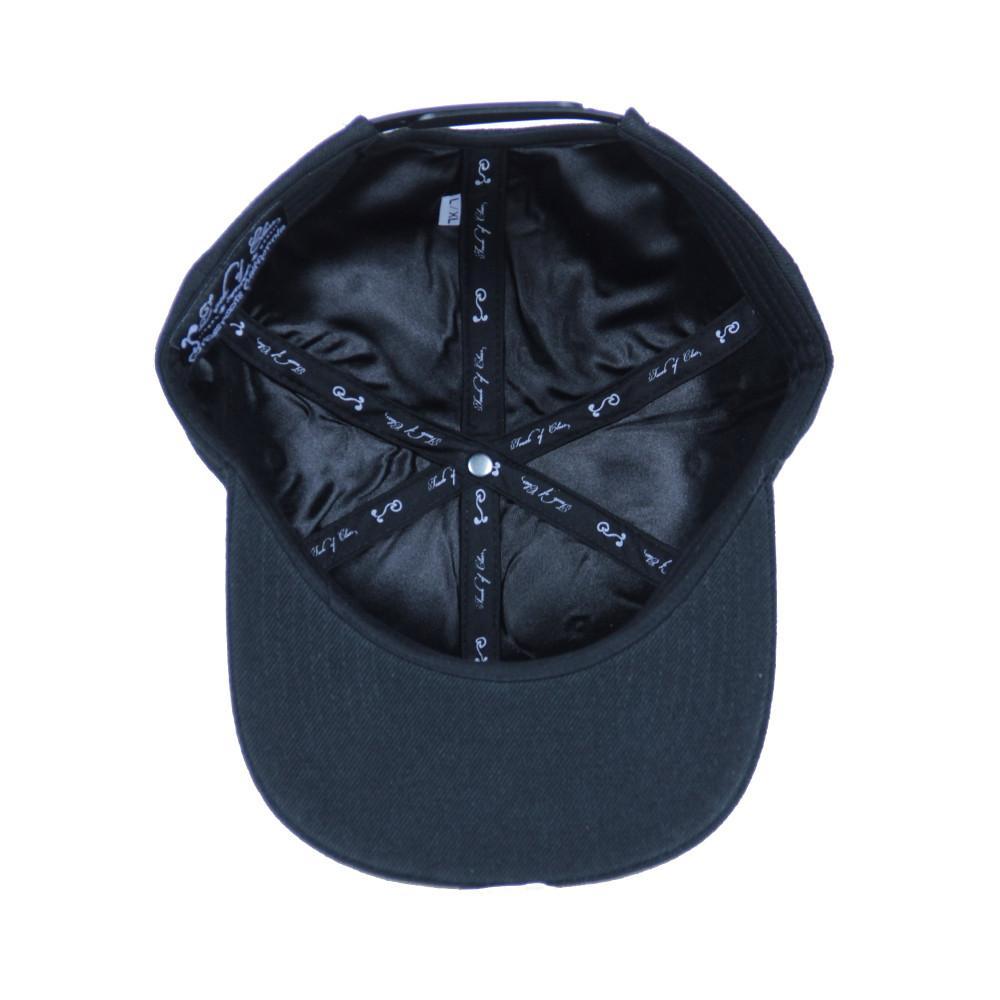 Black snapback hat interior view with stitched band and patterned lining