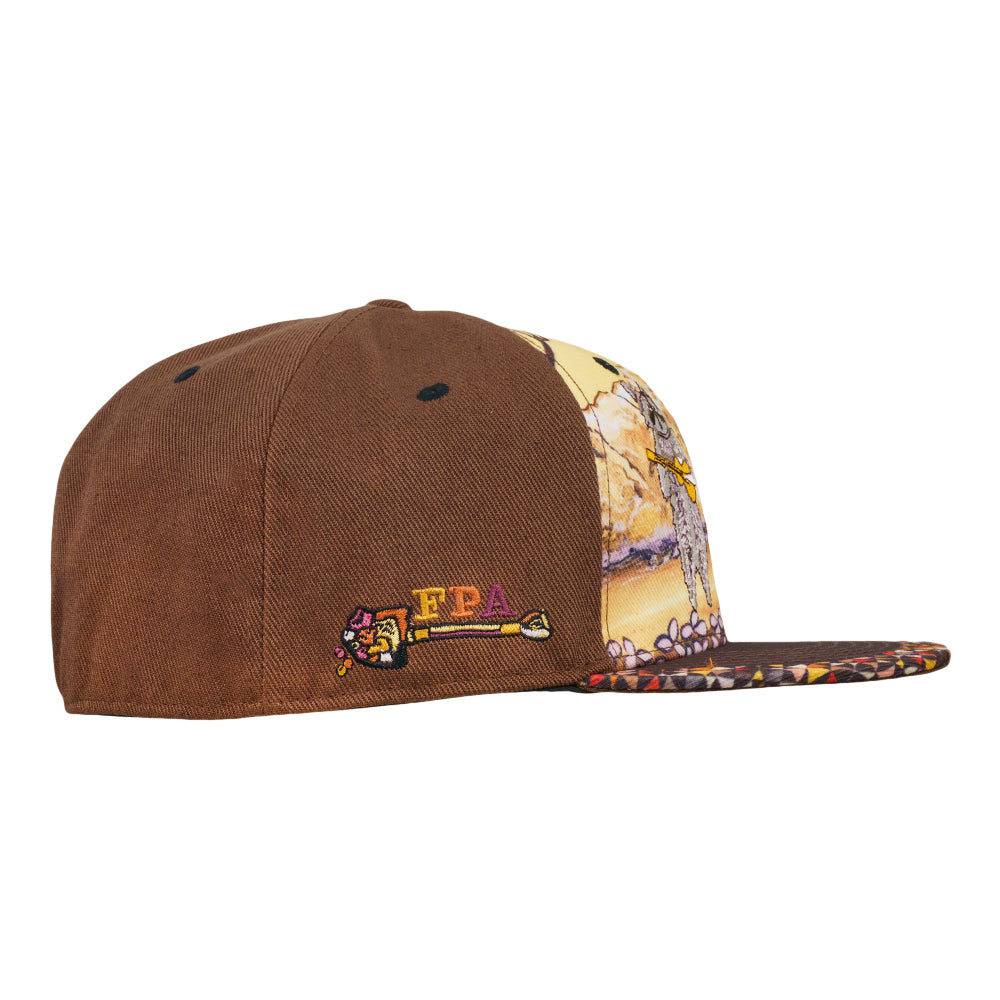 Brown fitted hat with embroidered logo patch and patterned side panel featuring raccoon artwork.