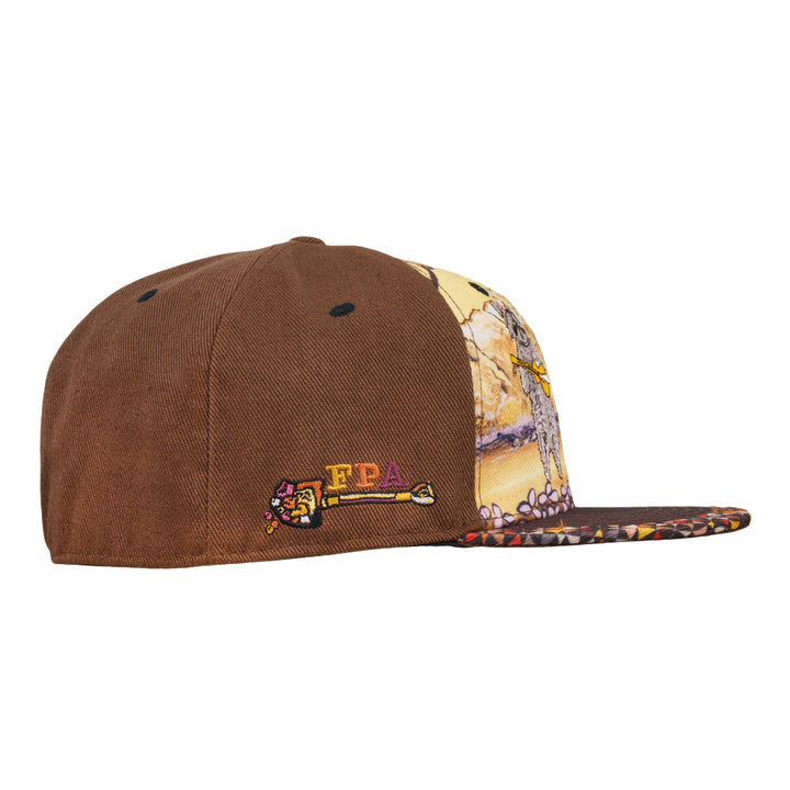 Brown fitted hat with embroidered logo patch and patterned side panel featuring raccoon artwork.