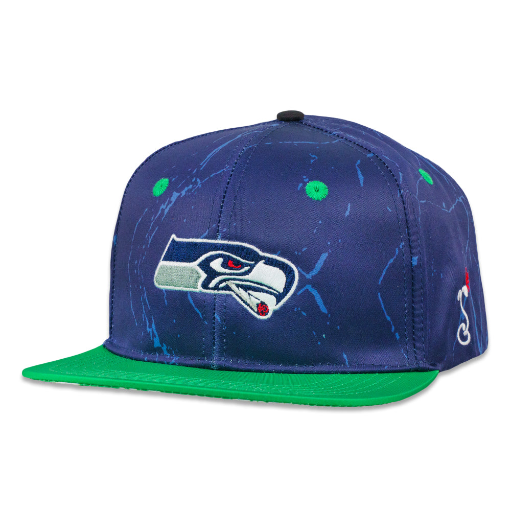 Navy snapback hat with green brim and white hawk logo on blue storm pattern.