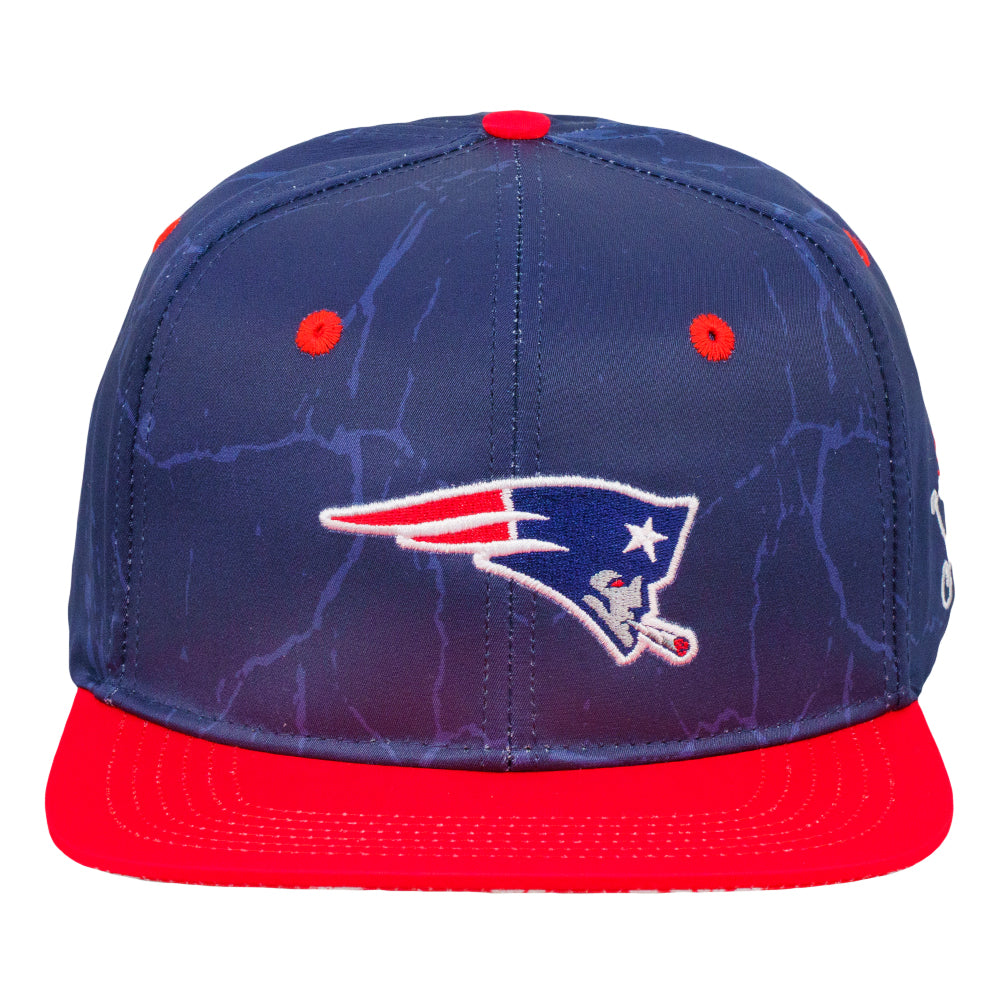Navy snapback hat with front sports logo and red brim close-up