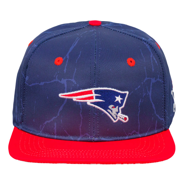 Navy snapback hat with front sports logo and red brim close-up
