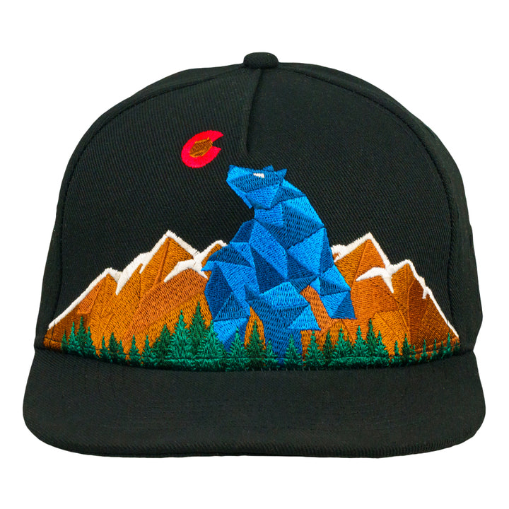 Black snapback hat front view with geometric bear, mountains, trees, and red accent