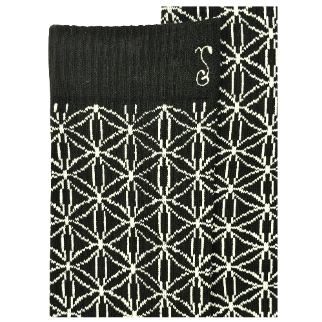 Close-up of black socks with white geometric lattice pattern and knit texture