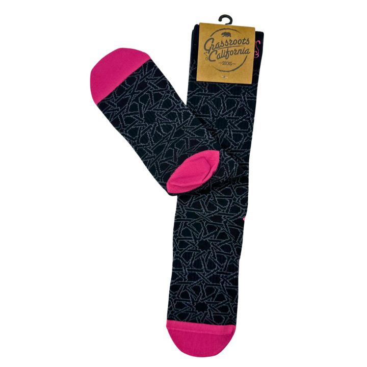 Black socks with geometric pattern and bright pink toe and heel, shown folded