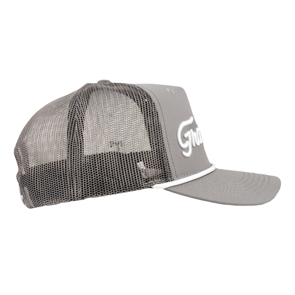 Gray mesh snapback hat side view with white script logo patch on crown