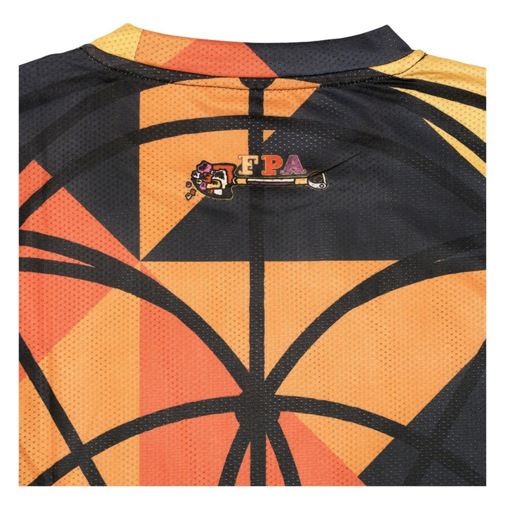 T-shirt back detail with 'FPA' label and orange black geometric pattern panel