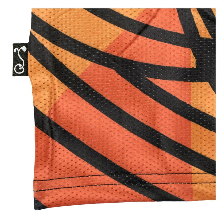 Multi-color T-shirt fabric corner with black wavy stripe and orange geometric print