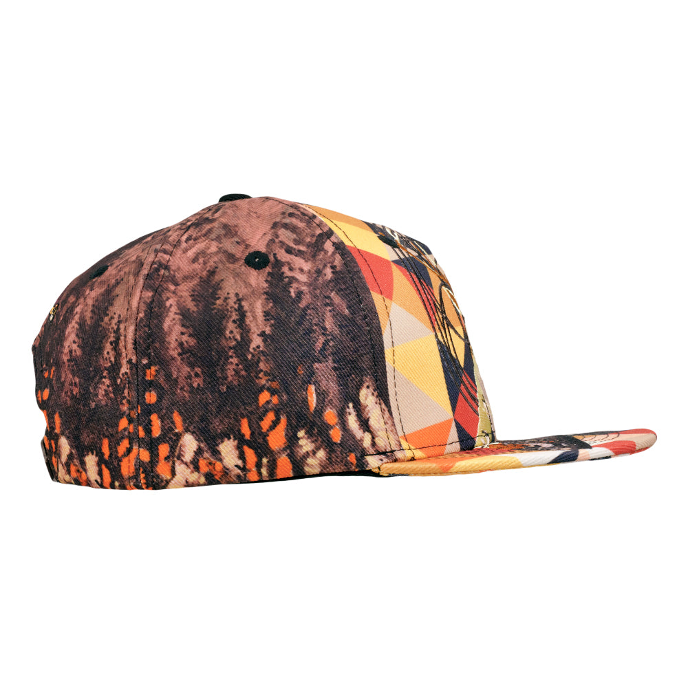 Snapback hat side view with marbled dark red, black, and geometric pattern brim.
