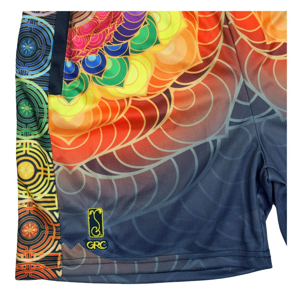 Mesh shorts close-up: multicolor scale print front, GRC emblem patch, dark gray base