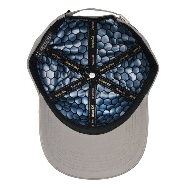 Gray dad hat with inside brim showing dark navy honeycomb lining and golf-themed text.