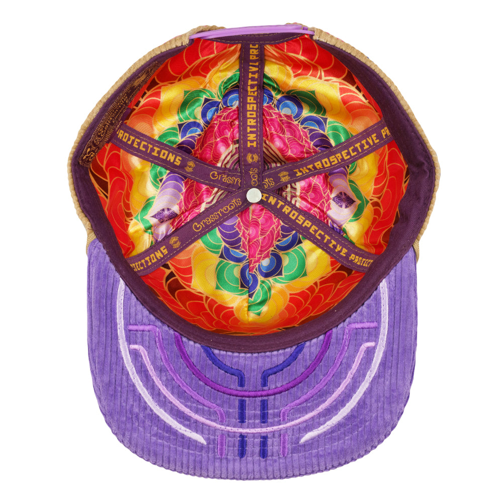 Tan snapback hat with purple brim; colorful printed interior lining visible