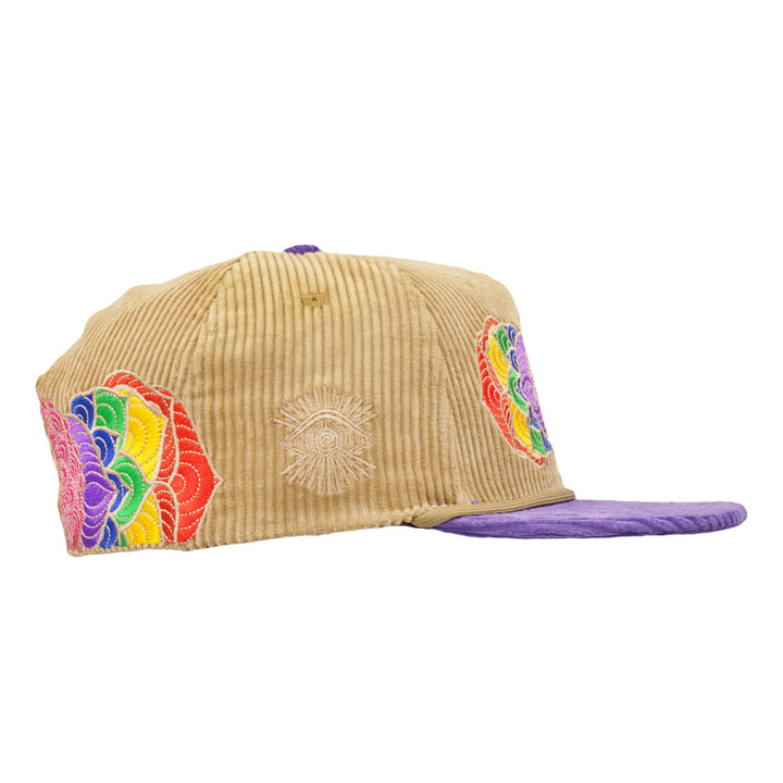 Tan corduroy snapback with purple brim and side rainbow flower embroidery patch