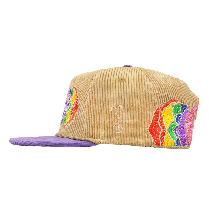 Tan corduroy snapback with purple brim; small white accent and side rainbow patches