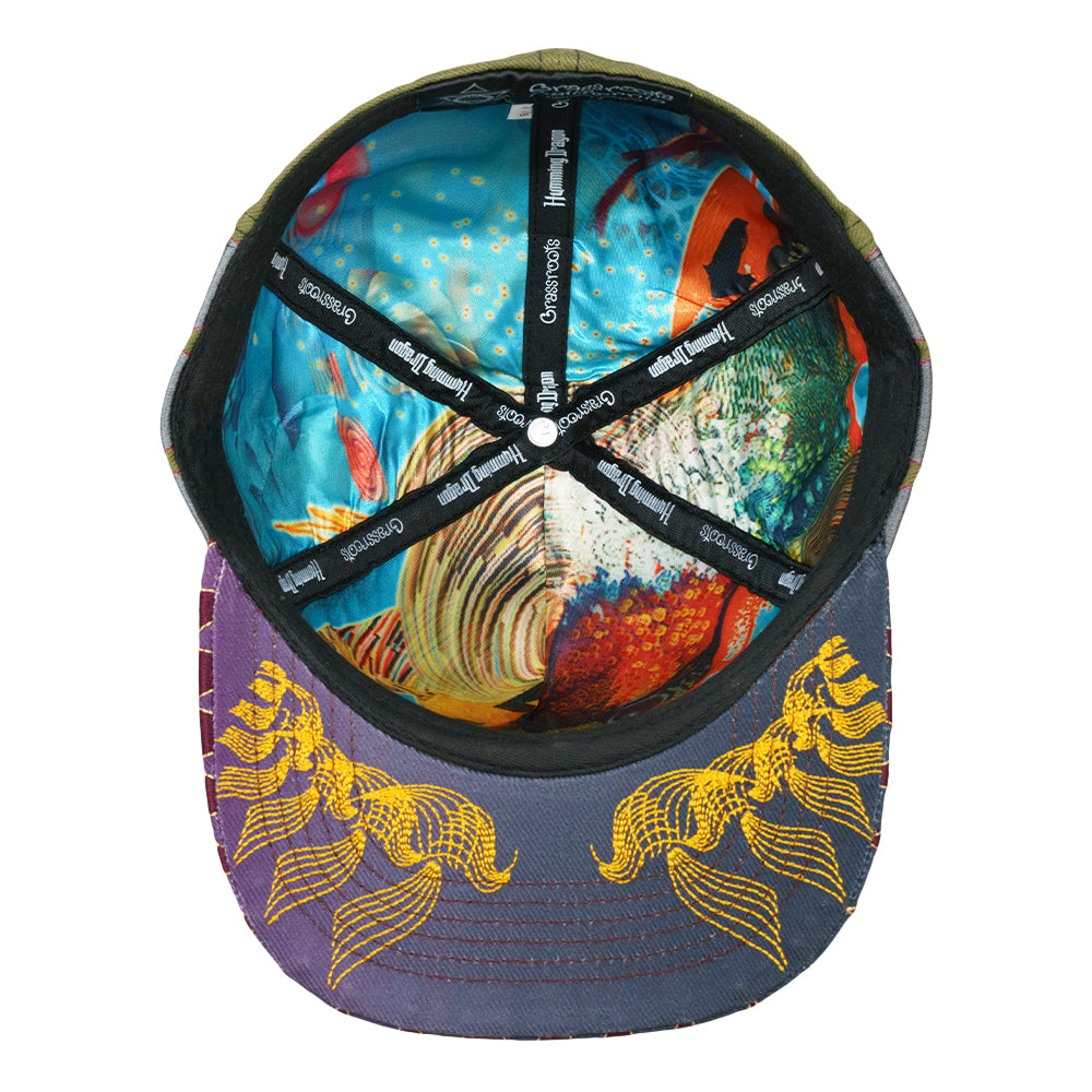Fitted hat interior with blue patterned lining and black eyelets stitched around crown