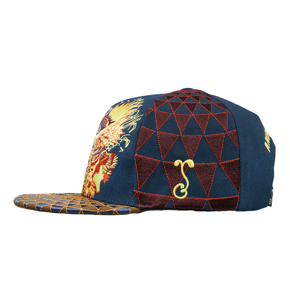 Navy snapback cap side with red geometric grid panel and small hook charm
