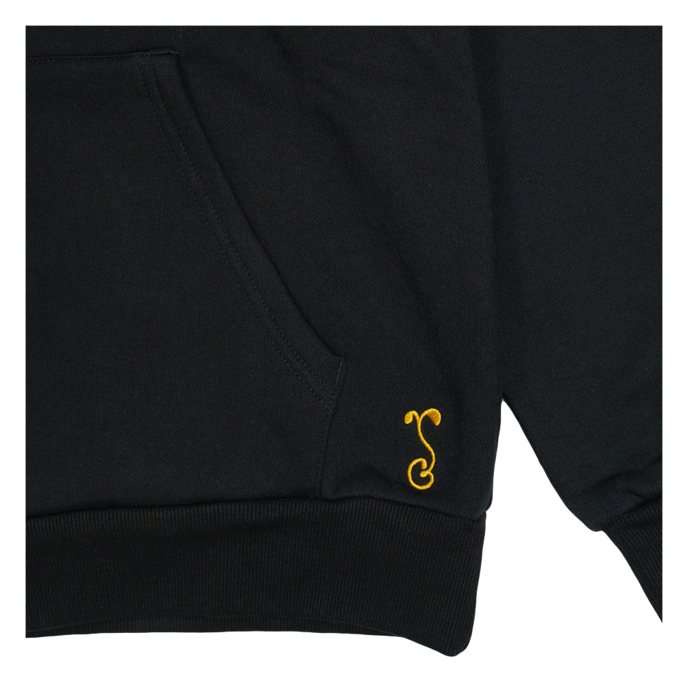 Black pullover hoodie sleeve cuff with small yellow emblem