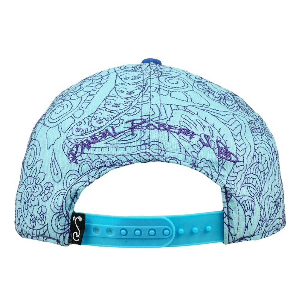 Back of snapback hat with blue patterned panels and an adjustable turquoise snap closure