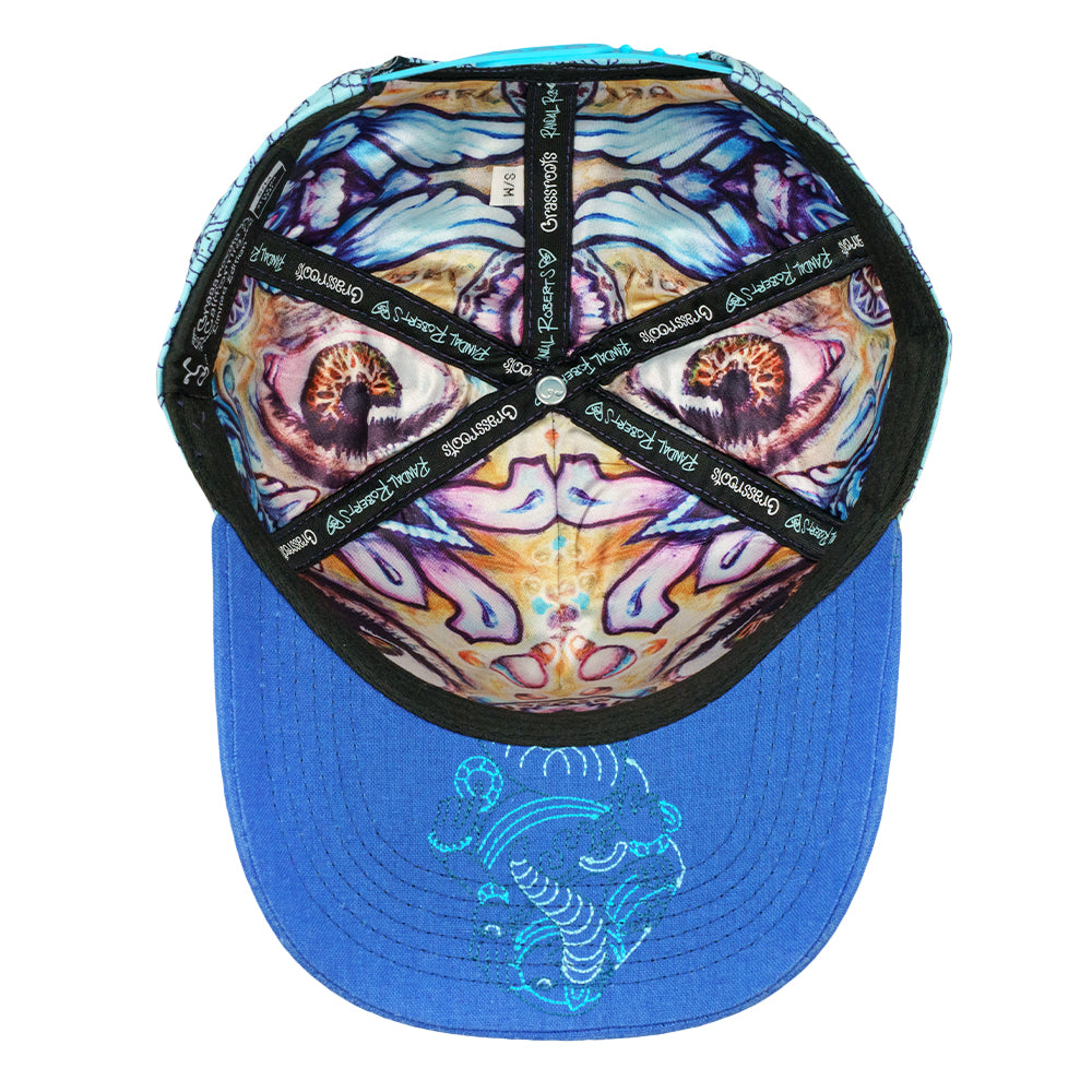 Snapback hat underside with a colorful printed lining and blue brim with embroidered detail