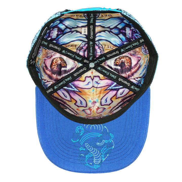 Snapback hat underside with a colorful printed lining and blue brim with embroidered detail