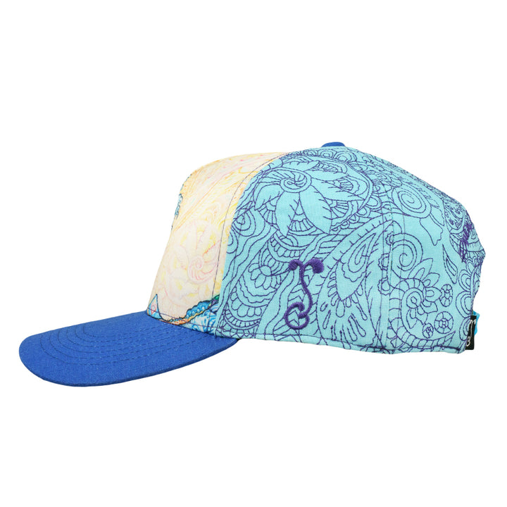 Opposite side of snapback hat showing blue patterned panels and a solid blue brim